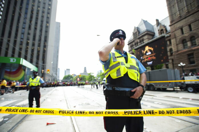 Toronto Police secure the scene after a shots were fired during the Toronto Raptors NBA basketball championship parade in Toronto, Monday, June 17, 2019. Photo: Andrew Lahodynskyj/The Canadian Press via AP Toronto Police secure the scene after a shots were fired during the Toronto Raptors NBA basketball championship parade in Toronto, Monday, June 17, 2019. Photo: Andrew Lahodynskyj/The Canadian Press via AP