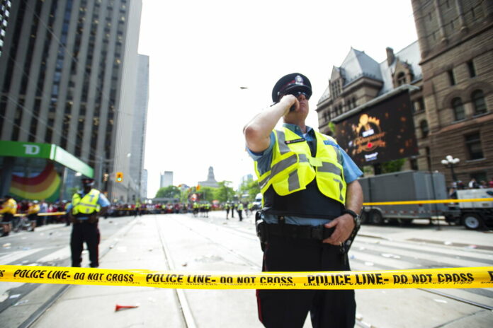 Toronto Police secure the scene after a shots were fired during the Toronto Raptors NBA basketball championship parade in Toronto, Monday, June 17, 2019. Photo: Andrew Lahodynskyj/The Canadian Press via AP