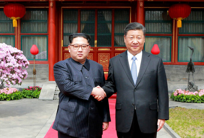 FILE - In this March 27, 2018, file photo, North Korean leader Kim Jong Un, left, shakes hands with Chinese counterpart Xi Jinping at Diaoyutai State Guesthouse in Beijing, China. Kim’s fifth meeting with Xi continues his ambitious diplomatic outreach that has included summits with the leaders of the United States, South Korea and Russia in the past year and a half. Experts say Kim is attempting to form a united front with North Korea’s main ally China to strengthen his leverage in the stalled nuclear negotiations with the United States. Photo: Korean Central News Agency/Korea News Service via AP, File