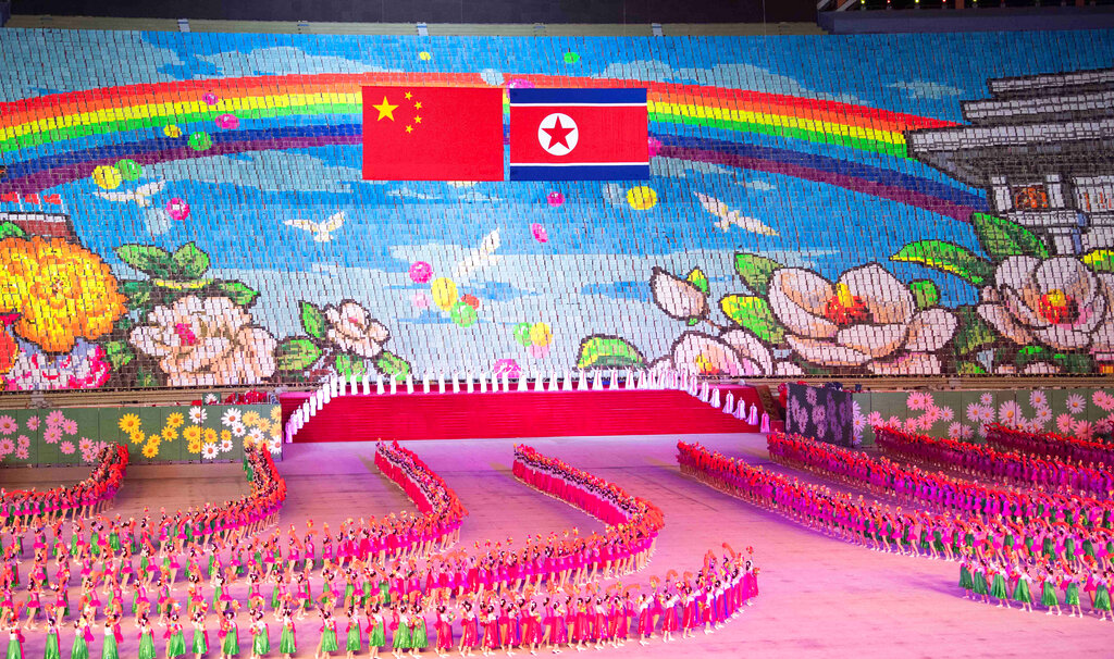 In this Thursday, June 20, 2019, photo released by China's Xinhua News Agency, Chinese, left, and North Korean flags are displayed during a mass gymnastic performance at the May Day Stadium in Pyongyang, North Korea. North Korean leader Kim Jong Un, meeting in Pyongyang with Chinese President Xi Jinping, said Thursday that his country is waiting for a desired response in stalled nuclear talks with the United States. Photo: Shen Hong/Xinhua via AP