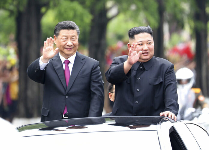 In this Thursday, June 20, 2019, photo released by China's Xinhua News Agency, visiting Chinese President Xi Jinping, left, and North Korean leader Kim Jong Un wave from an open top limousine as they travel along a street in Pyongyang, North Korea. North Korean leader Kim Jong Un, meeting in Pyongyang with Chinese President Xi Jinping, said Thursday that his country is waiting for a desired response in stalled nuclear talks with the United States. Photo: Ju Peng/Xinhua via AP