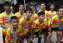 Wild Boars Mark Year Since Going Missing in Cave Members of the Wild Boars soccer team who were rescued from a flooded cave, pose for the media after a marathon and biking event in Mae Sai, Chiang Rai province, Thailand, Sunday, June 23, 2019. Some of the 12 young Thai soccer players and their coach have marked the anniversary of their ordeal that saw them trapped in a flooded cave for two weeks with a commemorative marathon in northern Thailand. Photo: Sakchai Lalit / AP