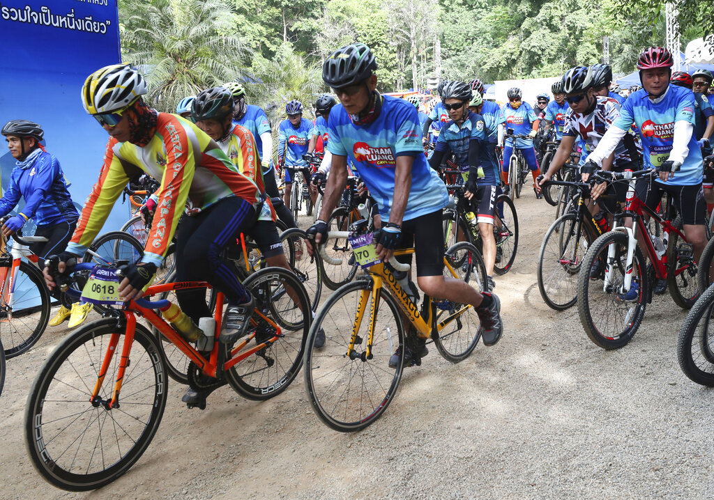 Participants start during a marathon and biking event in Mae Sai, Chiang Rai province, Thailand, Sunday, June 23, 2019. Around 4,000 took part in the event Sunday morning, organized by local authorities to raise funds to improve conditions at the now famous Tham Luang cave complex. The youngsters went in to explore before rain-fed floodwaters pushed them deep inside the dark complex. Their rescue was hailed as nothing short of a miracle. Photo: Sakchai Lalit / AP