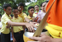 Cave Boys Mark Year Since Ordeal With Buddhist Rites Members of the Wild Boars soccer team who were rescued from a flooded cave, offer foods to a Buddhist monk near the Tham Luang cave in Mae Sai, Chiang Rai province, Thailand Monday, June 24, 2019. Photo: Sakchai Lalit / AP