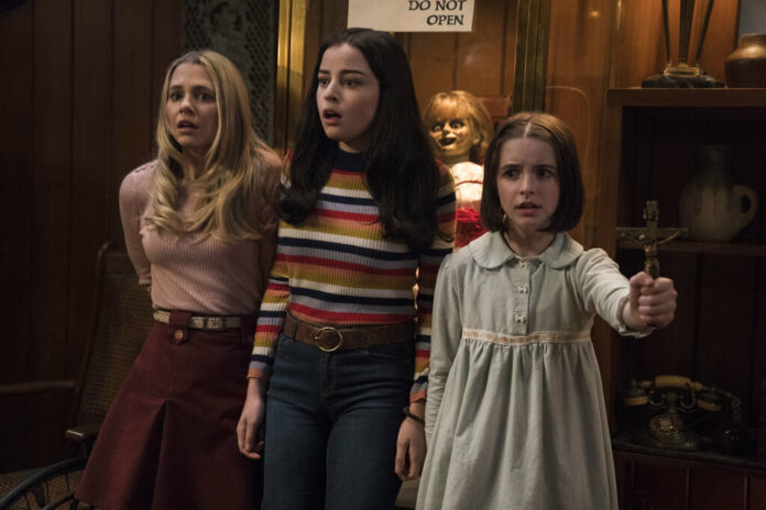 This image released by Warner Bros. Pictures shows Madison Iseman, from left, Katie Sarife and McKenna Grace in a scene from the horror film, 