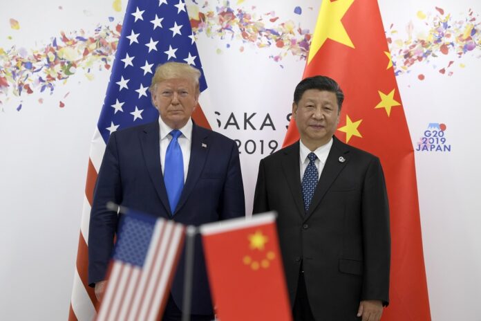 President Donald Trump, left, poses for a photo with Chinese President Xi Jinping during a meeting on the sidelines of the G-20 summit in Osaka, Japan, Saturday, June 29, 2019. (AP Photo/Susan Walsh)