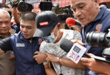 War of the Wins: Two Moto Drivers Arrested for Fatal Gunfight Pramuk Wichiandilokkun being escorted to Bangna Police Station on June 20.