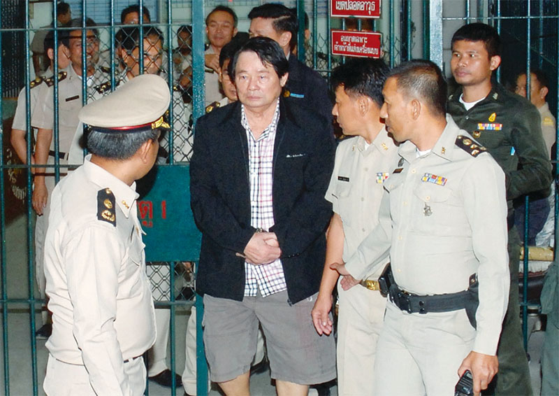 Kamnan Poh arrives at the Ratchadapisek Criminal Court on January 30, 2013, after his capture by police on the same day.