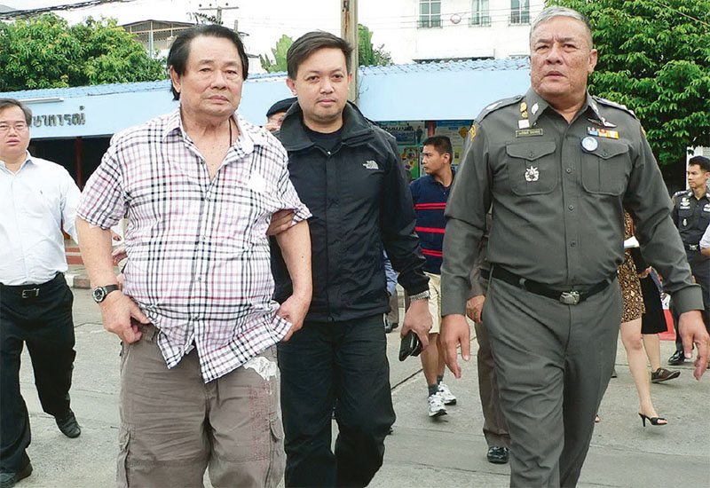 Kamnan Poh escorted by police in Bangkok on January 30, 2013, after his capture on the same day.