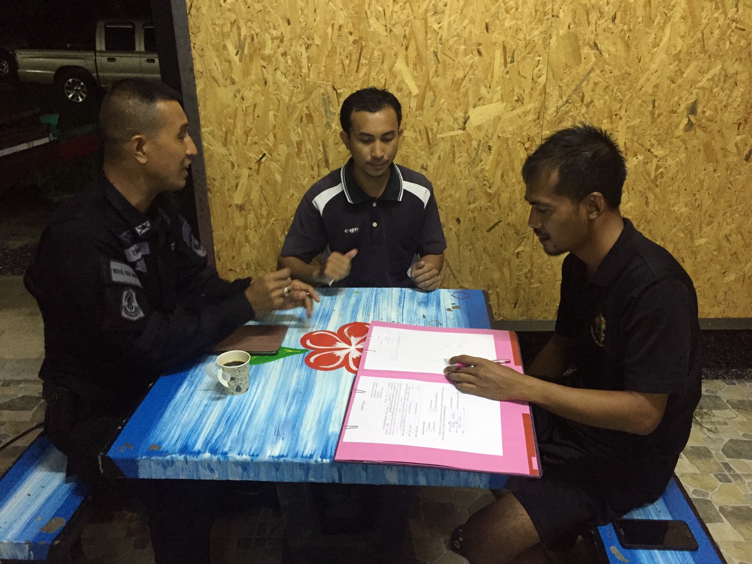 In this photo released by the ISOC, Abdullah Isomuso, center, is shown reading documents inside Fort Ingkhayut on July 20.