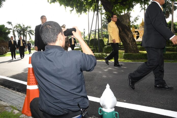 A reporter takes photos of junta chairman Prayuth Chan-ocha at Government House on July 15, 2019.