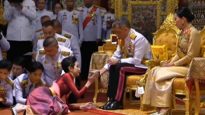King Rama X with royal noble consort Sineenat Wongvajirapakdi, left, on July 28, 2019.