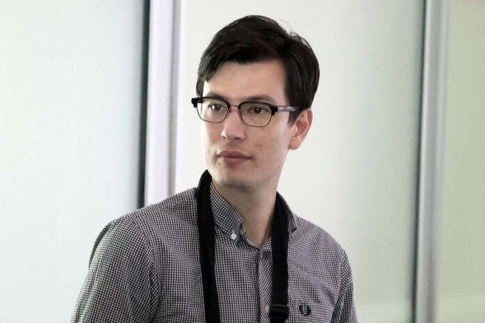 Australian student Alek Sigley arrives at Beijing Capital International Airport in Beijing, Thursday, July 4, 2019. (AP Photo/Mark Schiefelbein)