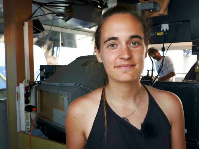 Sea-Watch 3 captain Carola Rackete is seen on board the vessel at sea in the Mediterranean, just off the coasts of the southern Italian island of Lampedusa, Thursday, June 27, 2019. The captain of the humanitarian rescue ship says that Italian law enforcement officials have told them that a resolution is near for 42 migrants rescued at sea that Italy’s populist government has so far refused to allow to disembark. Photo: ANSA/Matteo Guidelli via AP