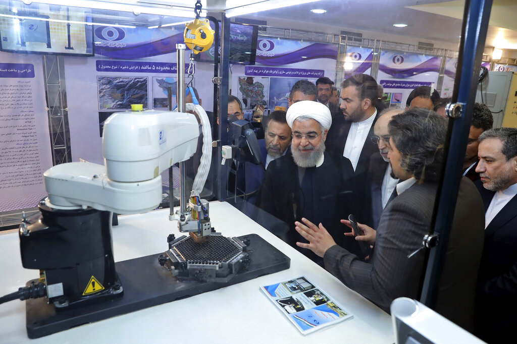 FILE - In this April 9, 2018, file photo, released by an official website of the office of the Iranian Presidency, President Hassan Rouhani listens to explanations on new nuclear achievements at a ceremony to mark "National Nuclear Day," in Tehran, Iran. Iranian Foreign Minister Mohammad Javad Zarif acknowledged Monday, July 1, 2019, Iran had broken the limit set on its stockpile of low-enriched uranium by the 2015 nuclear deal, marking its first major departure from the unraveling agreement a year after the U.S. unilaterally withdrew from the accord. Photo: Iranian Presidency Office via AP