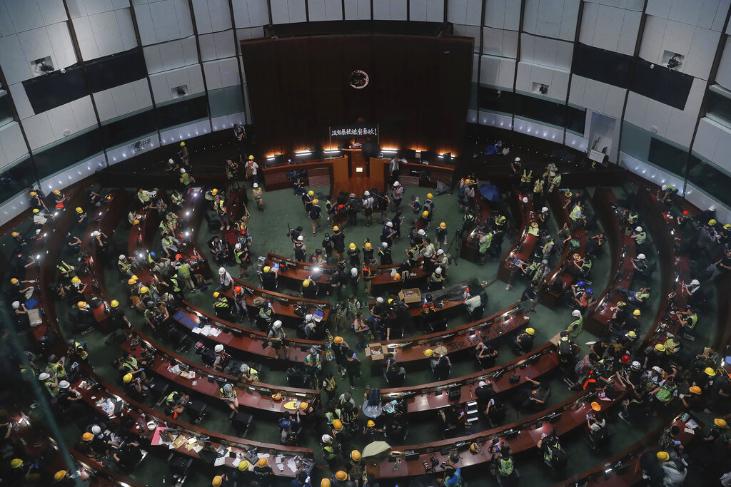 Protesters gather inside the meeting hall of the Legislative Council in Hong Kong, Monday, July 1, 2019. Protesters in Hong Kong took over the legislature's main building Friday night, tearing down portraits of legislative leaders and spray painting pro-democracy slogans on the walls of the main chamber. Photo: Kin Cheung