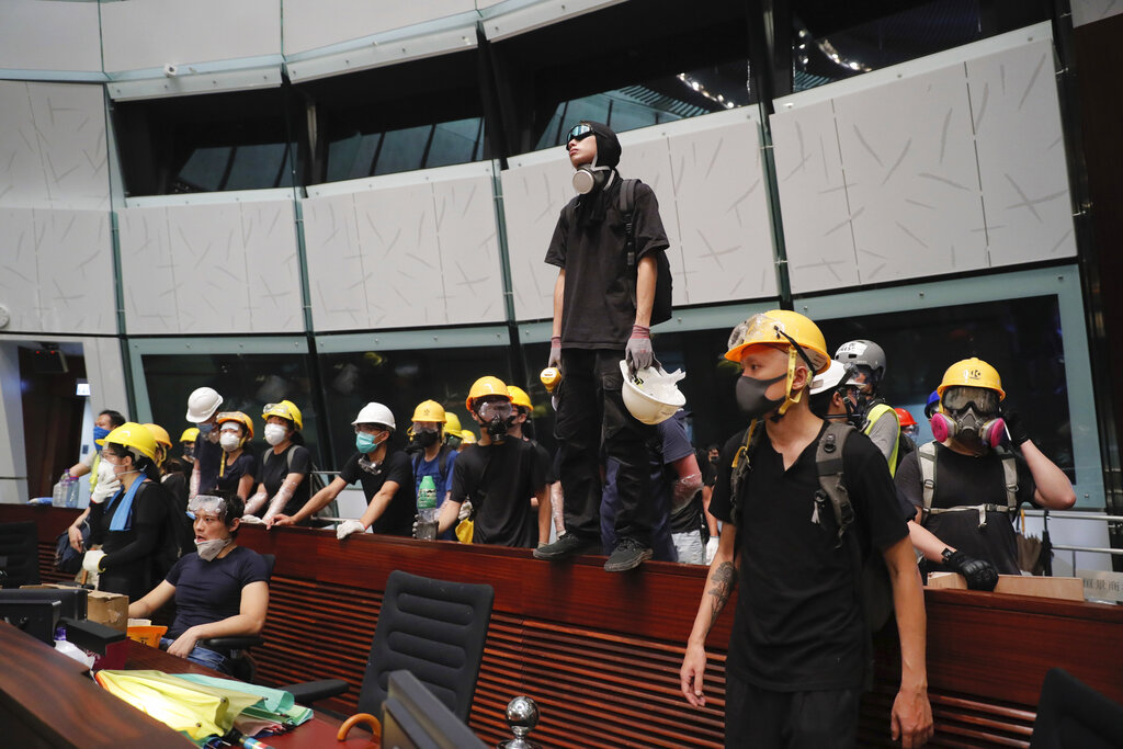 Protesters gather inside the meeting hall of the Legislative Council in Hong Kong, Monday, July 1, 2019. Protesters in Hong Kong took over the legislature's main building Friday night, tearing down portraits of legislative leaders and spray painting pro-democracy slogans on the walls of the main chamber. Photo: Kin Cheung