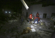 Airstrike Hits Migrant Detention Center in Libya, 40 Killed Libyan Red Crescent workers recover migrants bodies after an airstrike at a detention center in Tajoura, east of Tripoli Wednesday, July 3, 2019. An airstrike hit the detention center for migrants early Wednesday in the Libyan capital. Photo: Hazem Ahmed / AP