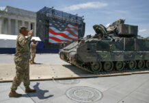 Trump Vows July 4 ‘Show of a Lifetime’ as Protesters Gather Army soldiers with the 3rd Infantry Division, 1st Battalion, 64th Armored Regiment, move a Bradley Fighting Vehicle into place by the Lincoln Memorial, Wednesday, July 3, 2019, in Washington, ahead of planned Fourth of July festivities with President Donald Trump. Photo: Jacquelyn Martin / AP