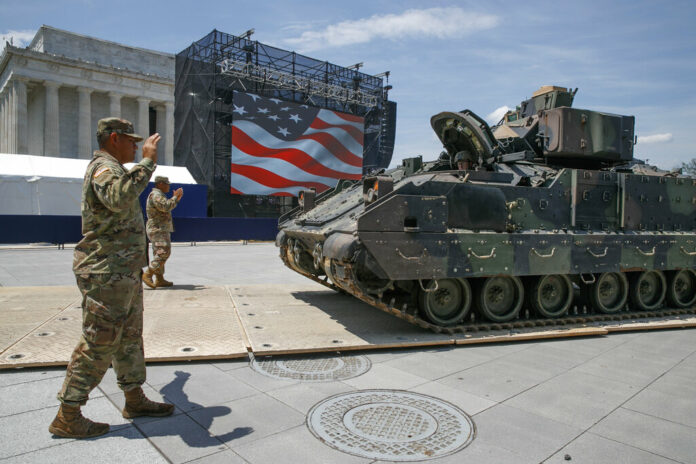 Army soldiers with the 3rd Infantry Division, 1st Battalion, 64th Armored Regiment, move a Bradley Fighting Vehicle into place by the Lincoln Memorial, Wednesday, July 3, 2019, in Washington, ahead of planned Fourth of July festivities with President Donald Trump. Photo: Jacquelyn Martin / AP