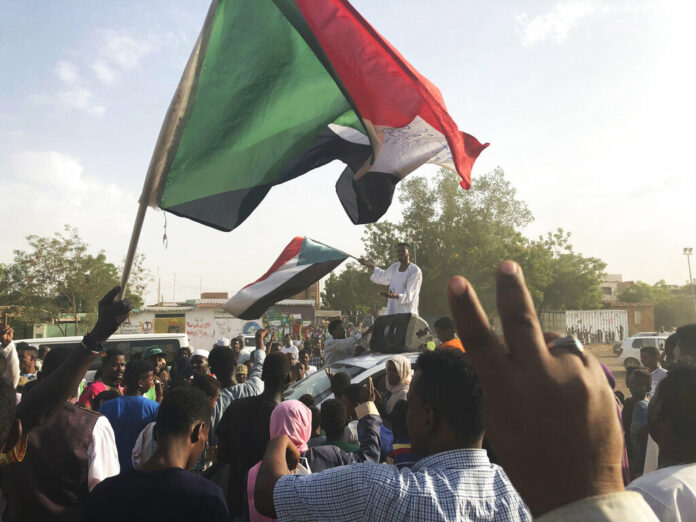 Sudanese people celebrate in the streets of Khartoum after ruling generals and protest leaders announced they have reached an agreement on the disputed issue of a new governing body on Friday, July 5, 2019. The deal raised hopes it will end a three-month political crisis that paralyzed the country and led to a violent crackdown that killed scores of protesters. Photo: AP Sudanese people celebrate in the streets of Khartoum after ruling generals and protest leaders announced they have reached an agreement on the disputed issue of a new governing body on Friday, July 5, 2019. The deal raised hopes it will end a three-month political crisis that paralyzed the country and led to a violent crackdown that killed scores of protesters. Photo: AP