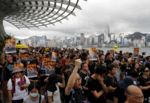 Tens of Thousands in Hong Kong Take Message to Mainlanders Protesters take part in a march in Hong Kong on Sunday, July 7, 2019. Protesters in Hong Kong are taking their message to visitors from mainland China on Sunday in a march to a high-speed rail station that connects to Guangdong city and other mainland destinations. Photo: Kin Cheung / AP