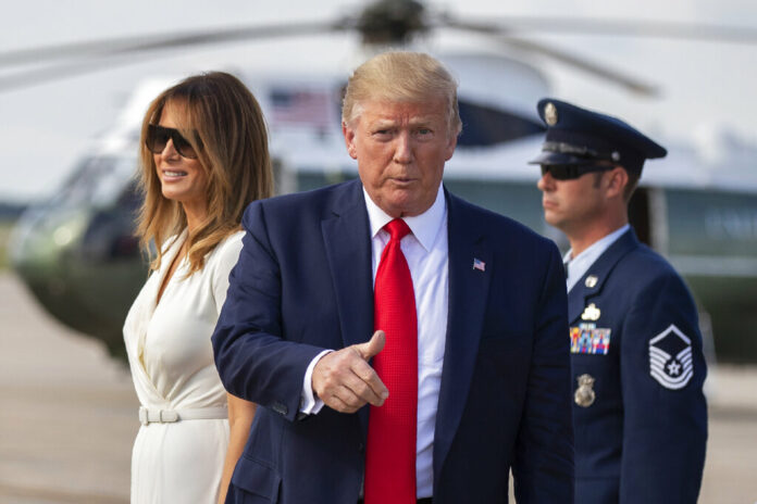 President Donald Trump with first lady Melania Trump gestures upon arrival at Andrews Air Force Base, Md., Sunday, July 7, 2019. Photo: Manuel Balce Ceneta / AP