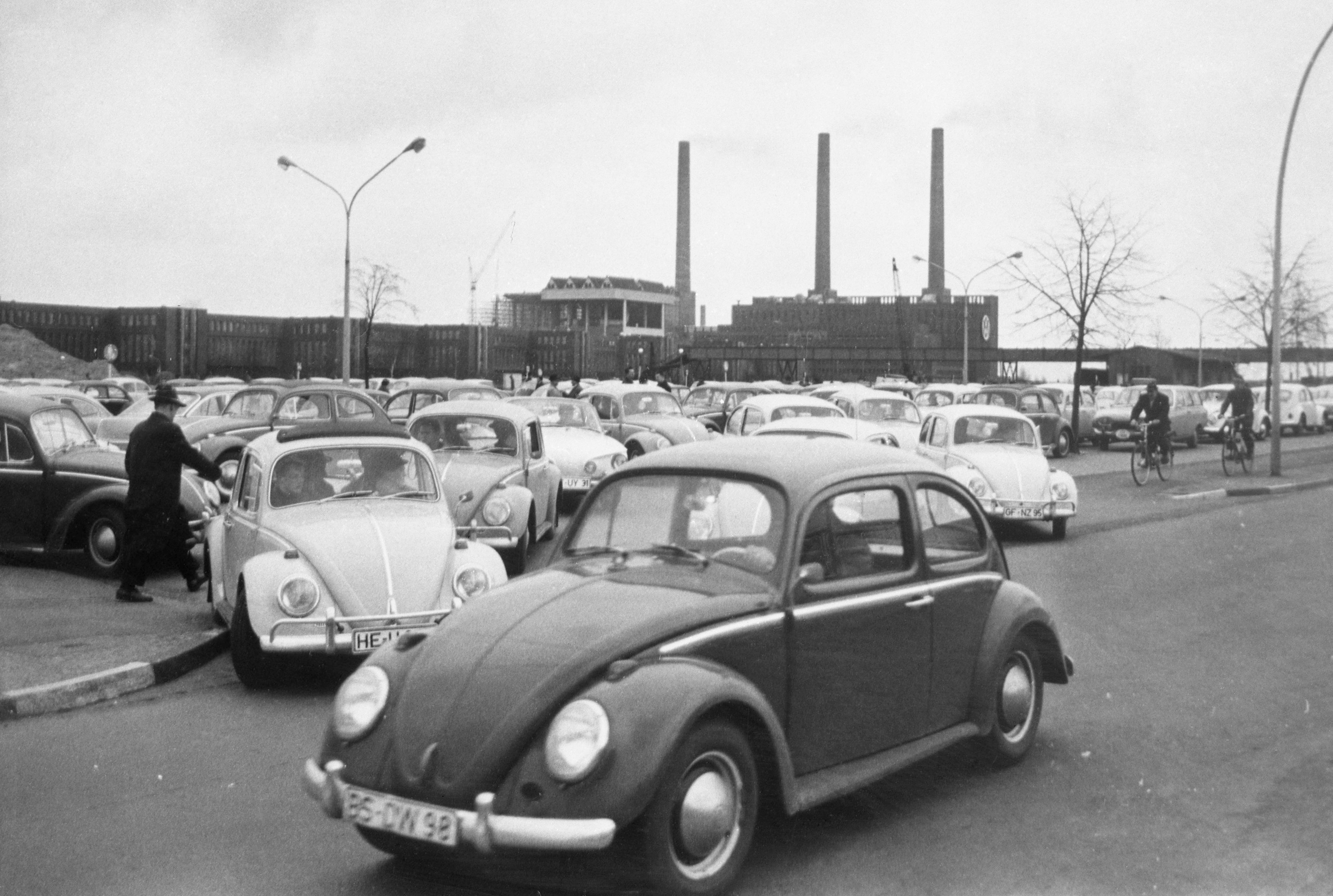 In this April 27, 1966 file photo, Volkswagen workers drive their Beetle cars from the parking lot on their way home at the end of a days work at the world's largest single auto plant, the Volkswagen factory (seen in background) in Wolfsburg, Germany. Photo: AP