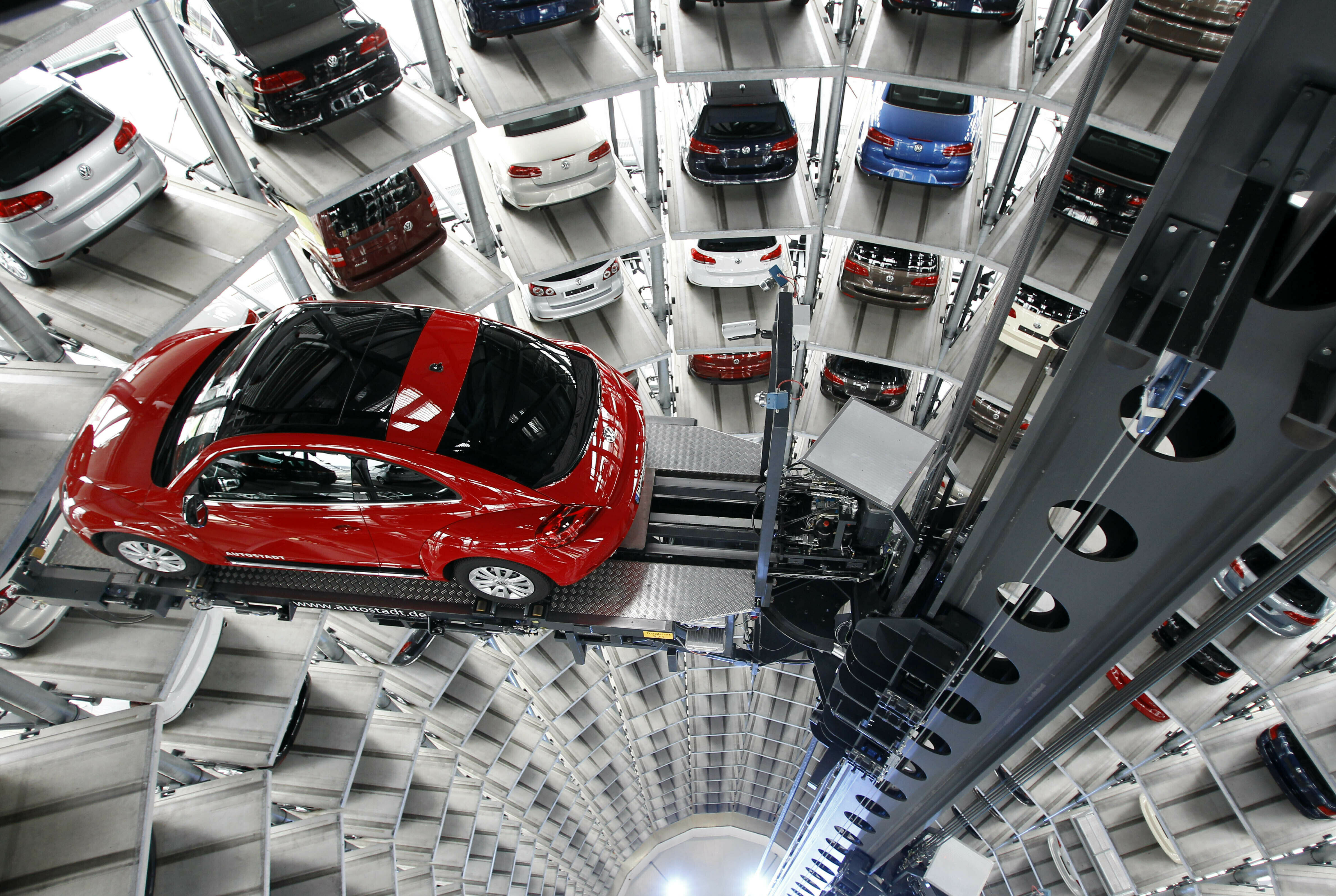 In this March 12, 2012, file photo a Volkswagen New Beetle car is lifted inside a delivery tower after the company's annual press conference in Wolfsburg, Germany. Photo: Michael Sohn / AP
