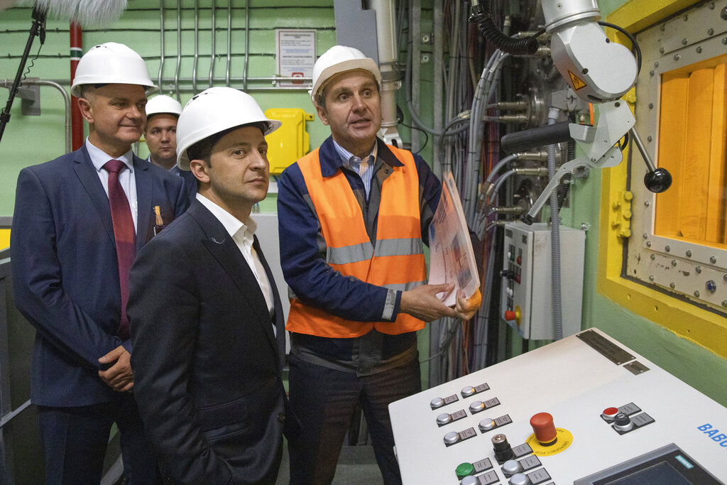 Ukrainian President Volodymyr Zelenskiy, foreground, visits the "new safe confinement" shelter that spans the remains of the Chernobyl nuclear power plant's Reactor No. 4, in Chernobyl, Ukraine, Wednesday, July 10, 2019. A structure built to confine radioactive dust from the nuclear reactor at the center of the 1986 Chernobyl disaster was formally unveiled on Wednesday. Photo: Ukrainian Presidential Press Office via AP