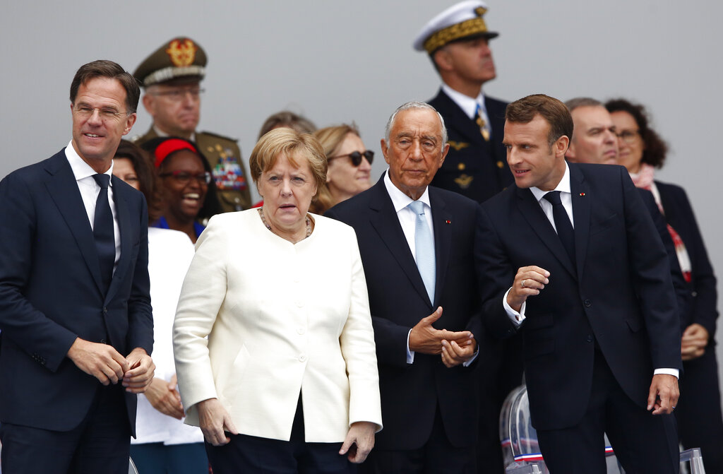 From the left, Dutch Prime Minister Mark Rutte, German Chancellor Angela Merkel, Portugal's President Marcelo Rebelo de Sousa and French President Emmanuel Macron, attend Bastille Day parade Sunday, July 14, 2019 on the Champs Elysees avenue in Paris. Photo: Kamil Zihnioglu / AP