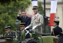 France Trumpets Shared European Defense on Bastille Day (Photos) France's President Emmanuel Macron gestures in his command car next to French Armies Chief Staff General Francois Lecointre as they review troops before the start of the Bastille Day military parade down the Champs-Elysees avenue in Paris Sunday, July 14, 2019. French President Emmanuel Macron has overseen France's annual Bastille Day celebration, which this year showcased European defense cooperation. Photo: Eliot Blondet / POOL via AP