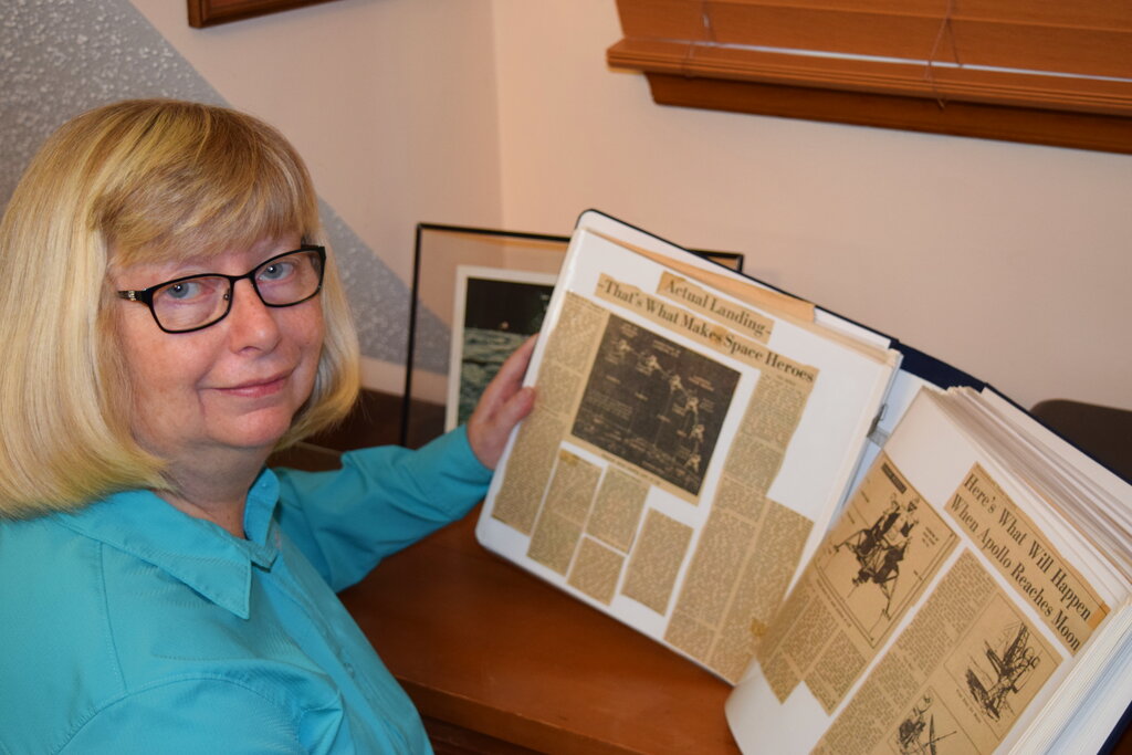 This 2019 photo provided by Cathy Goff shows her with newspaper clippings about the Apollo 11 moon landing mission at her home in King, N.C. Photo: Courtesy Cathy Goff via AP