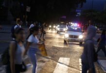 Venezuela Capital in the Dark Again After Massive Blackout People cross a street during a blackout in Caracas, Venezuela, Monday, July 22, 2019. The lights went out across much of Venezuela Monday, reviving fears of the blackouts that plunged the country into chaos a few months ago as the government once again accused opponents of sabotaging the nation's hydroelectric power system. Photo: Ariana Cubillos / AP