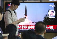N. Korea Fires Missiles Into Sea in Apparent Pressure Tactic People watch a TV showing a file image of North Korea's missile launch during a news program at the Seoul Railway Station in Seoul, South Korea, Thursday, July 25, 2019. North Korea fired two unidentified projectiles into the sea on Thursday, South Korea's military said, the first launches in more than two months as North Korean and U.S. officials work to restart nuclear diplomacy. The signs read: "North Korea fired unidentified projectiles into the sea." Photo: Ahn Young-joon / AP