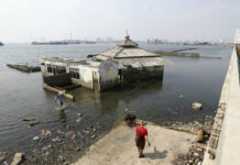 Indonesia’s Leader Says Sinking Jakarta Needs Giant Sea Wall People walk near a giant sea wall which is used as a barrier to prevent sea water from flowing into land and cause flooding in Jakarta, Indonesia, Saturday, July 27, 2019. Photo: Achmad Ibrahim / AP