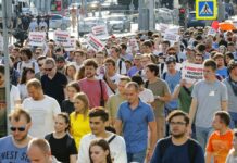 Nearly 1,400 Detained in Moscow Protest; Largest in Decade Protesters hold posters that read: "I have the right to my candidate" during an unsanctioned rally in the center of Moscow, Russia, Saturday, July 27, 2019. Photo: Alexander Zemlianichenko / AP
