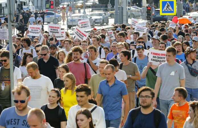 Russia Opposition Protest Protesters hold posters that read:
