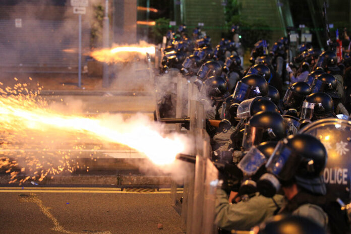 Hong Kong police fire tear gas at protesters in Sai Wan, Hong Kong on Sunday, July 28, 2019. Photo: Jeff Cheng / HK01 via AP