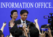 China Defends Hong Kong Police, Blames Western Forces Yang Guang, spokesman of the Hong Kong and Macau Affairs Office of the State Council, gestures as reporters approach him after a press conference about the ongoing protests in Hong Kong, at the State Council Information Office in Beijing, Monday, July 29, 2019. Photo: Andy Wong / AP