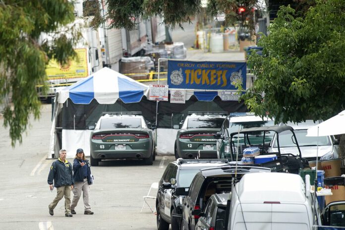 FBI personnel pass a ticket booth at the Gilroy Garlic Festival Monday, July 29, 2019 in Calif., the morning after a gunman killed at least three people, including a 6-year-old boy, and wounding about 15 others. Photo: Noah Berger / AP