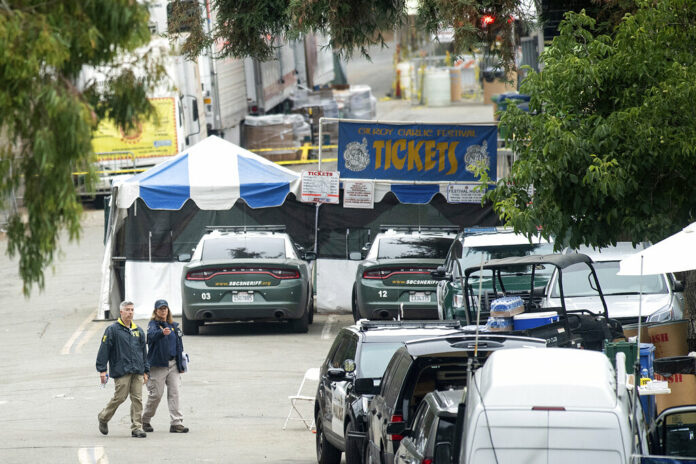 FBI personnel pass a ticket booth at the Gilroy Garlic Festival Monday, July 29, 2019 in Calif., the morning after a gunman killed at least three people, including a 6-year-old boy, and wounding about 15 others. Photo: Noah Berger / AP FBI personnel pass a ticket booth at the Gilroy Garlic Festival Monday, July 29, 2019 in Calif., the morning after a gunman killed at least three people, including a 6-year-old boy, and wounding about 15 others. Photo: Noah Berger / AP