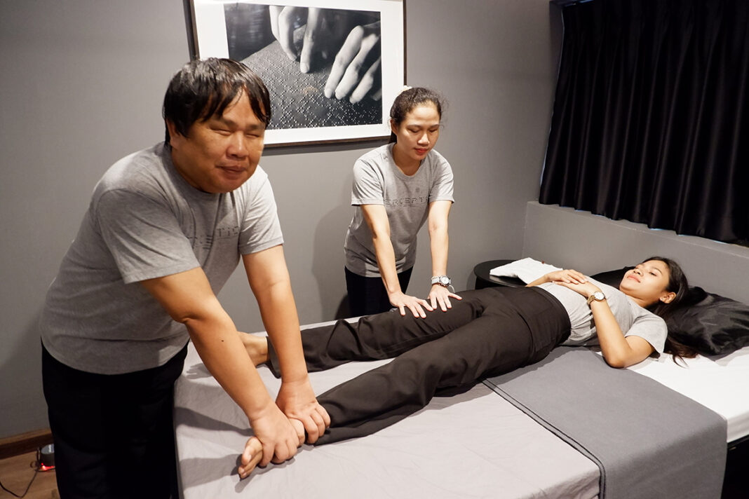 Anant “Nat” Kumsawang and Chutima “Yui” Panpong massaging another employee of Perception Massage.