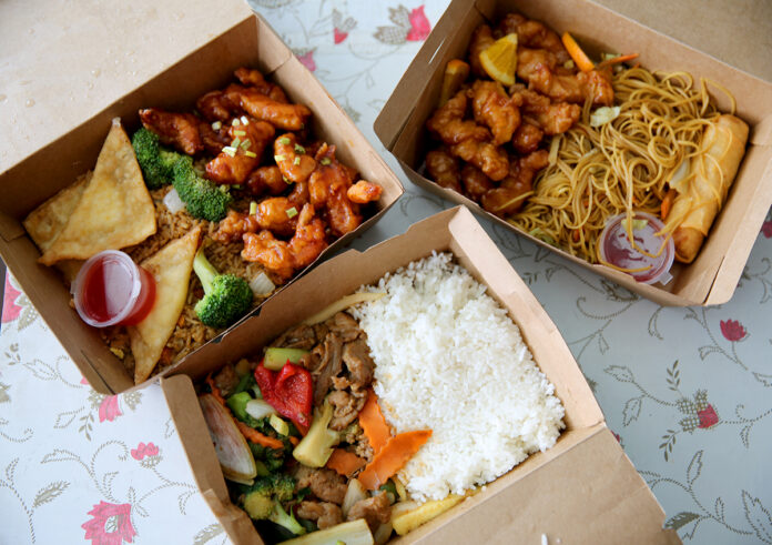 Clockwise from left: General Tao's Chicken and Cheese Puffs with fried rice (240 baht), Orange Chicken and Egg Roll (240 baht with an added 30 baht for vegetable lo mein), and the Mandarin Beef with white rice (220 baht).