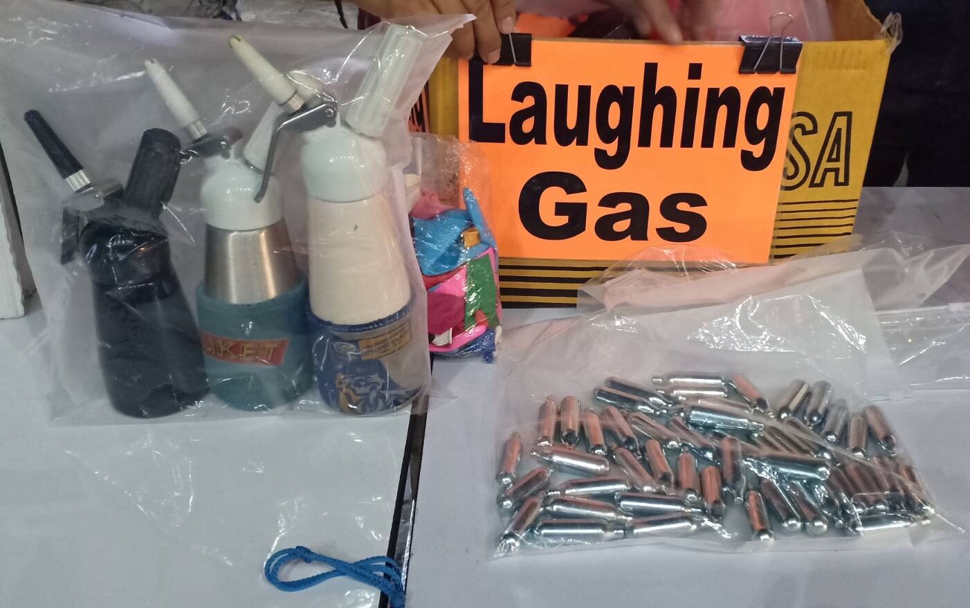 Whipped-cream chargers filled with nitrous oxide were found during the raid on July 11.