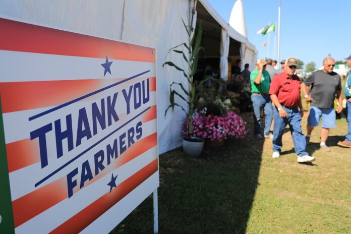 Farmers walk past the entrance to attend Farmfest in Redwood County of Minnesota, the United States, Aug. 8, 2019. (Xinhua/Zhang Mocheng)
