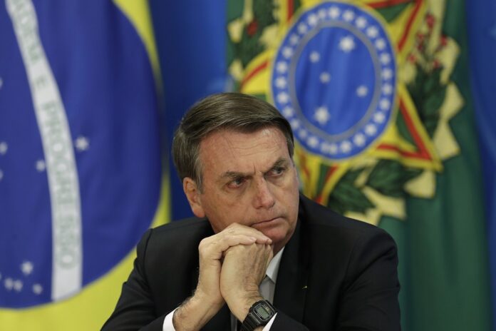 Brazil's President Jair Bolsonaro holds a press conference on deforestation in the Amazon at the Planalto presidential palace in Brasilia, Brazil, Thursday, Aug. 1, 2019. (AP Photo/Eraldo Peres)