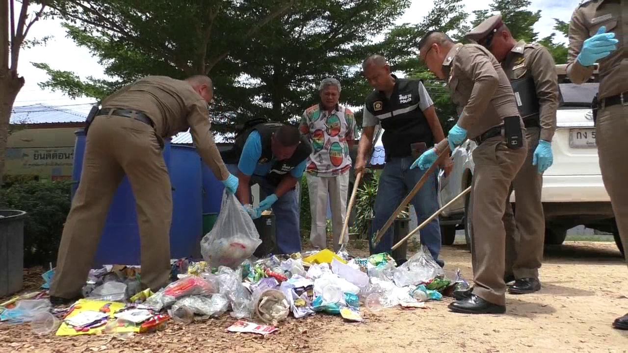 Police examining the trash can for evidence on Aug. 23.