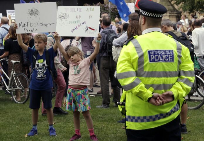Anti-Brexit supporters take part in a protest at College Green near the Houses of Parliament in central London, Wednesday, Aug. 28, 2019. (AP Photo/Matt Dunham)