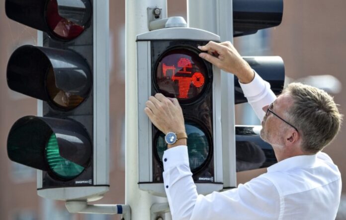 Director of Moesgaard Museum Mads Kähler Holst replaces the first of many pedestrian signals for Viking signals in Aarhus, Denmark, Monday, Aug. 26, 2019. (Photo: Henning Bagger / Ritzau Scanpix via AP)